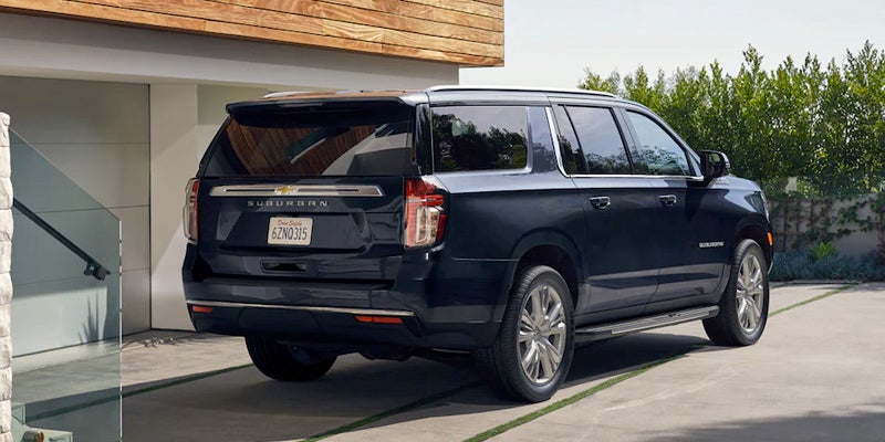 2023 Chevrolet Suburban Parked Next to A House